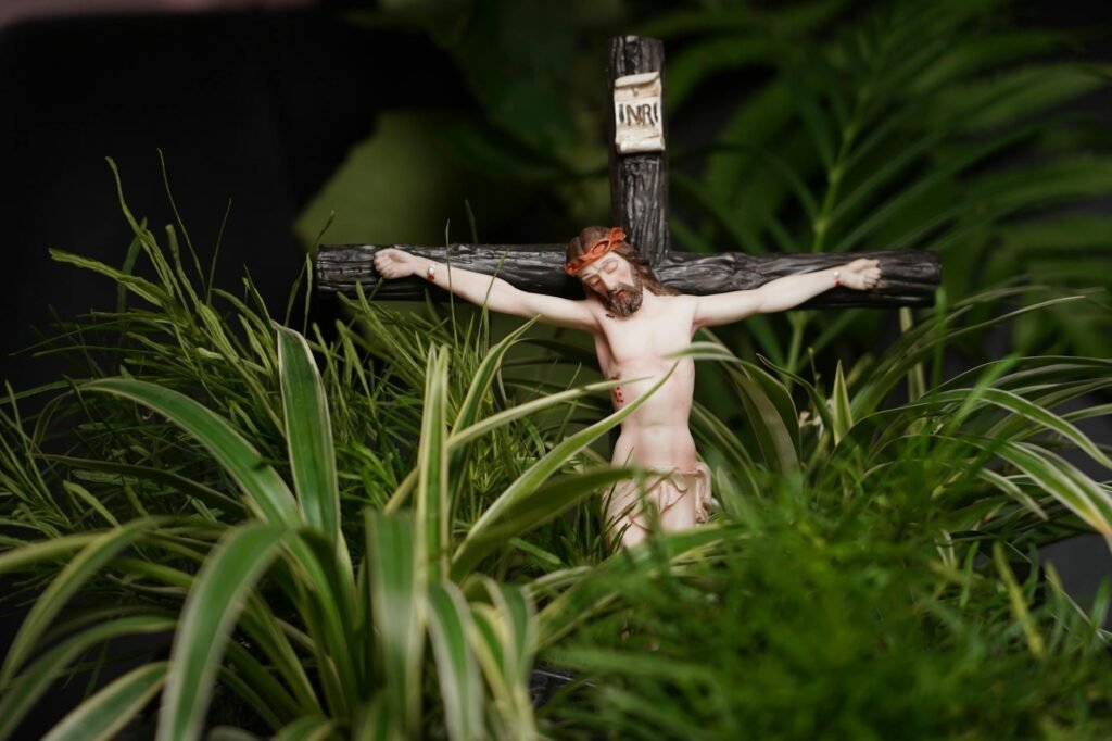 a crucifix beside the green grass